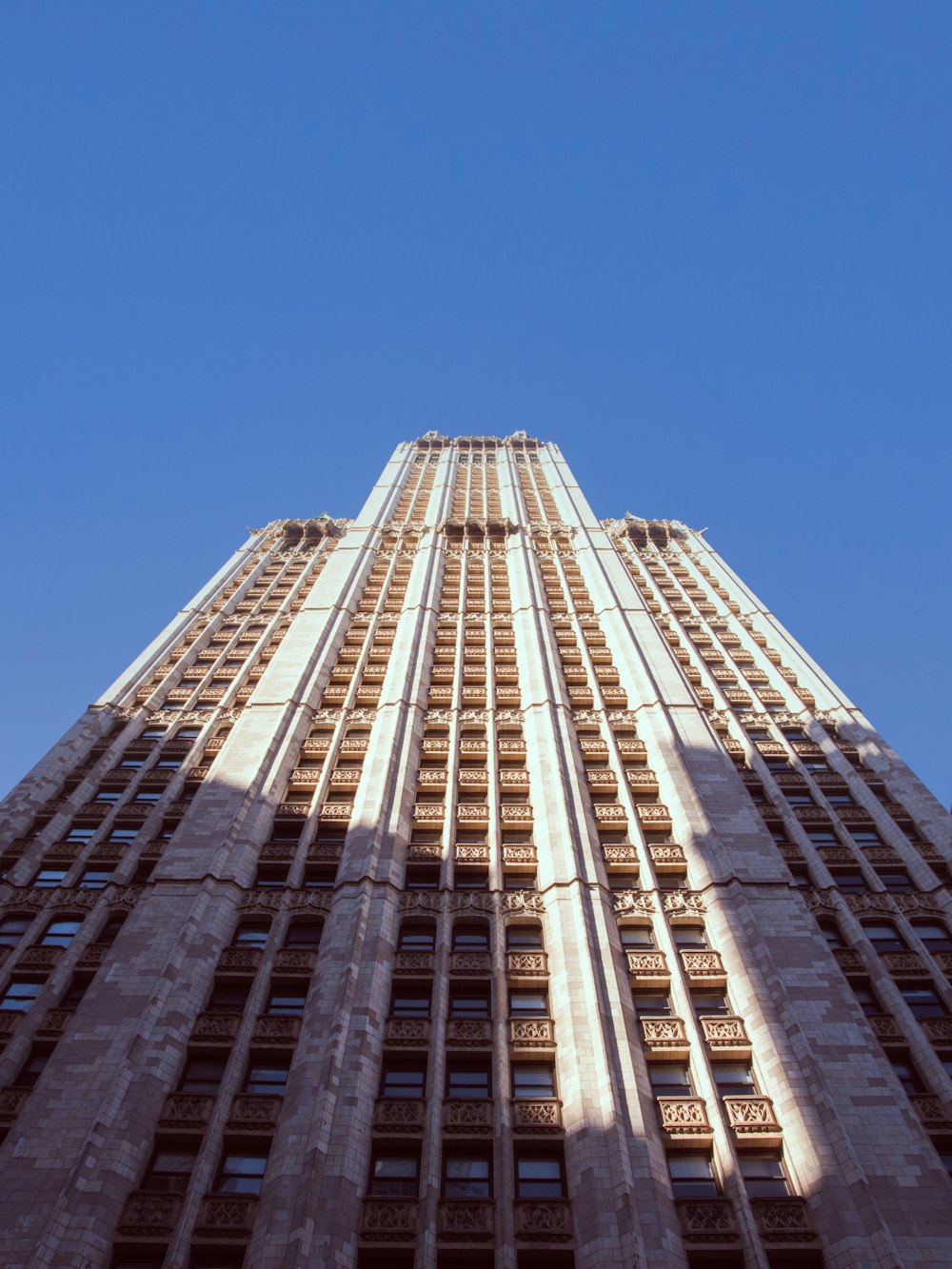 looking up at the top of a tall building