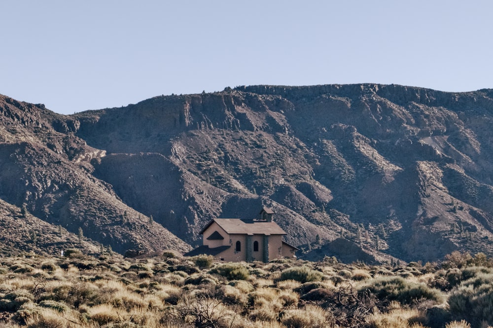 a house in the middle of a mountain range