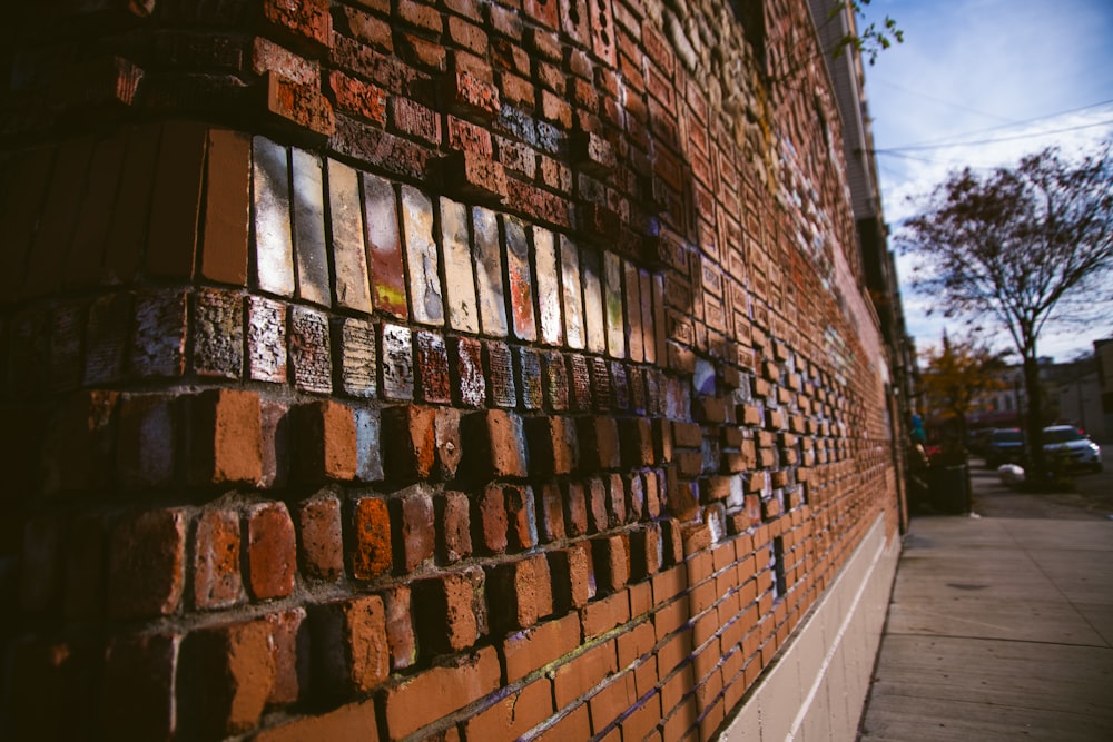 a brick wall with many different colored bricks on it