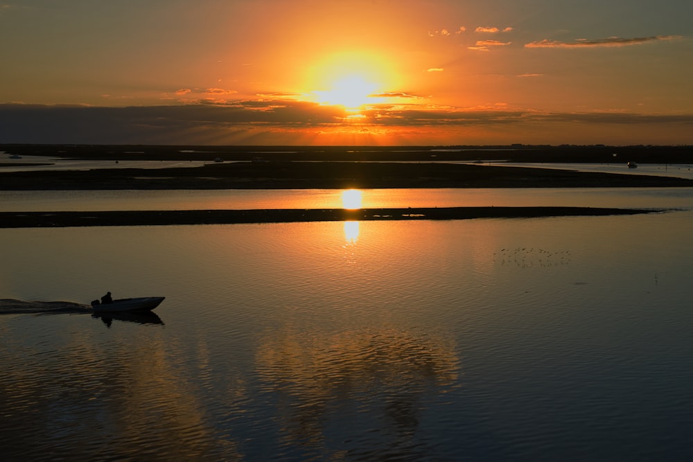 a small boat floating on top of a body of water