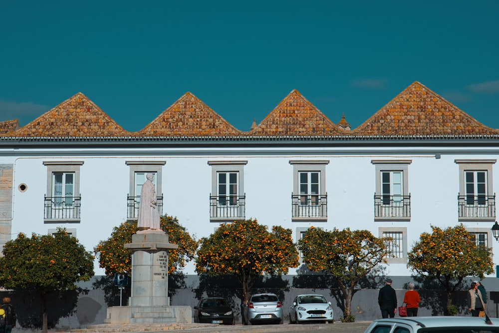 a white building with a statue in front of it