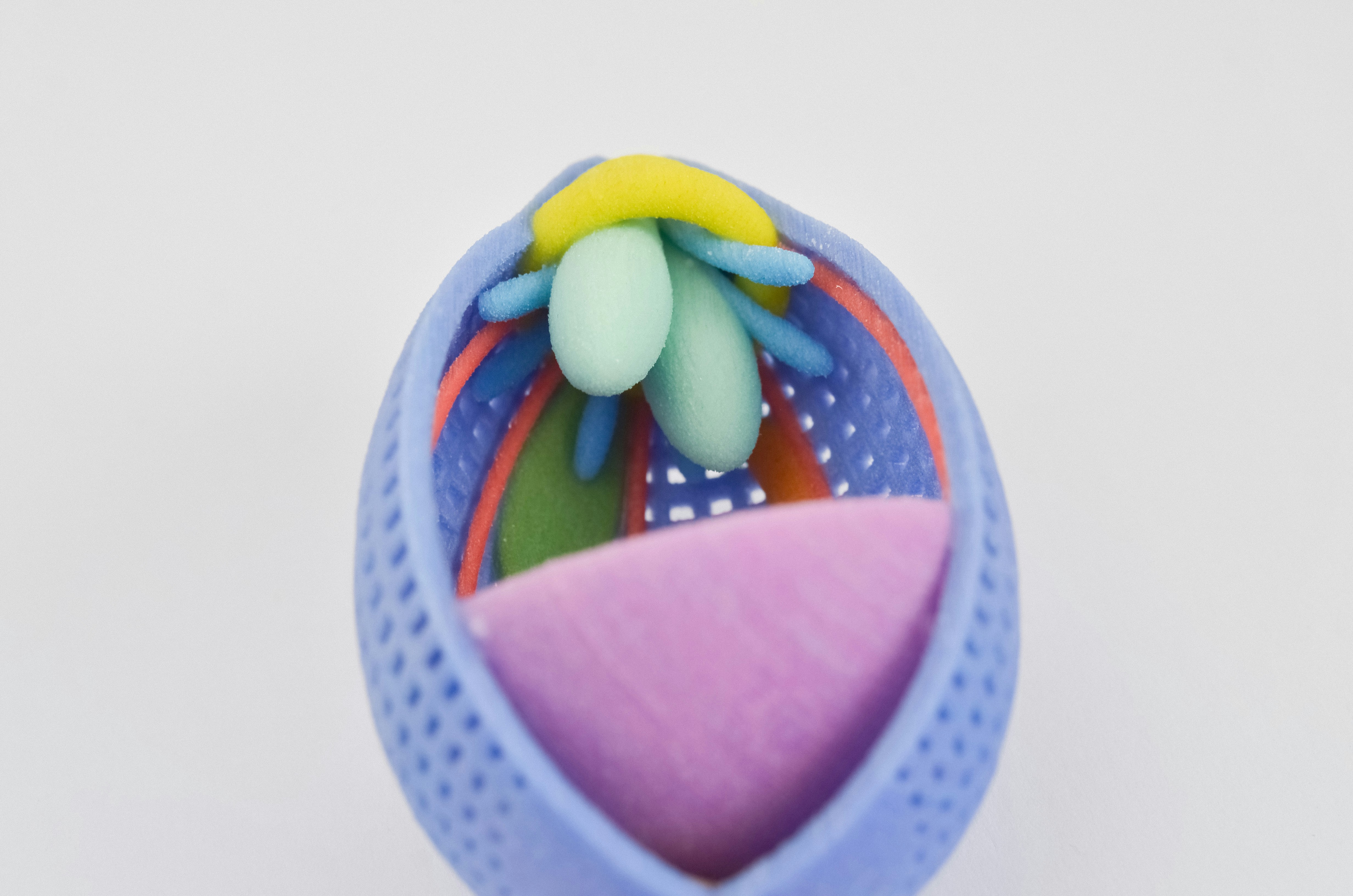 a close up of a plastic object on a white surface