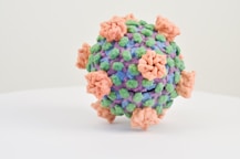 a multicolored ball of yarn on a white surface