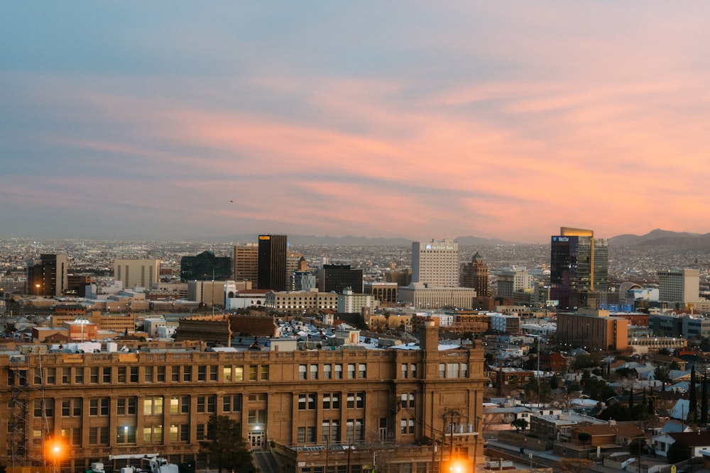 a view of a city at sunset from a hill