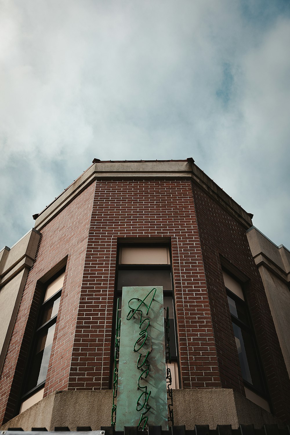 a tall brick building with a sign on the side of it