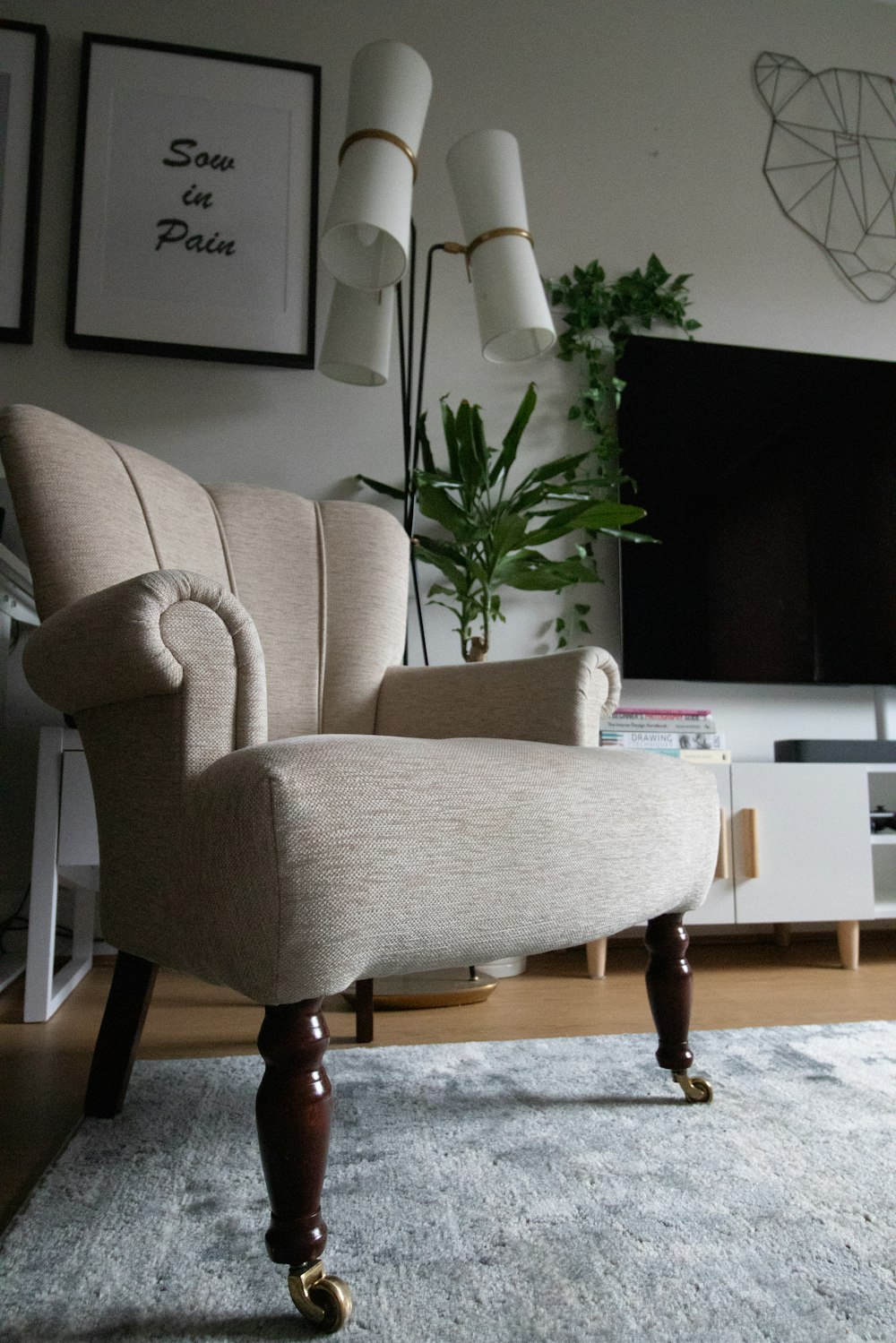 a living room with a chair and a television
