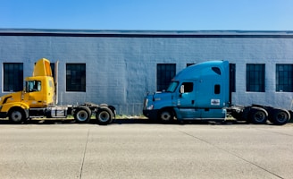 two semi trucks parked in front of a building