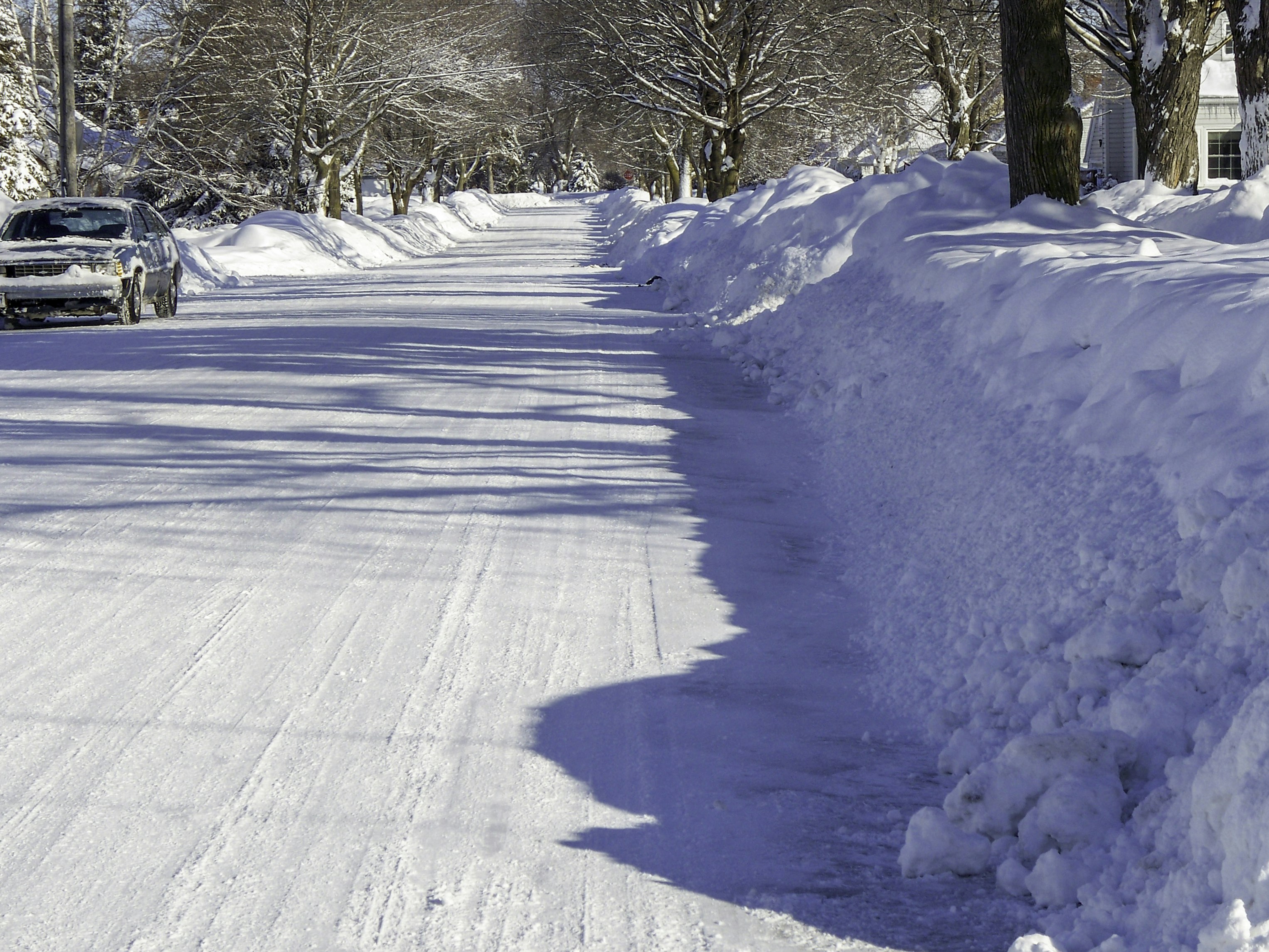 a car driving down a snow covered road