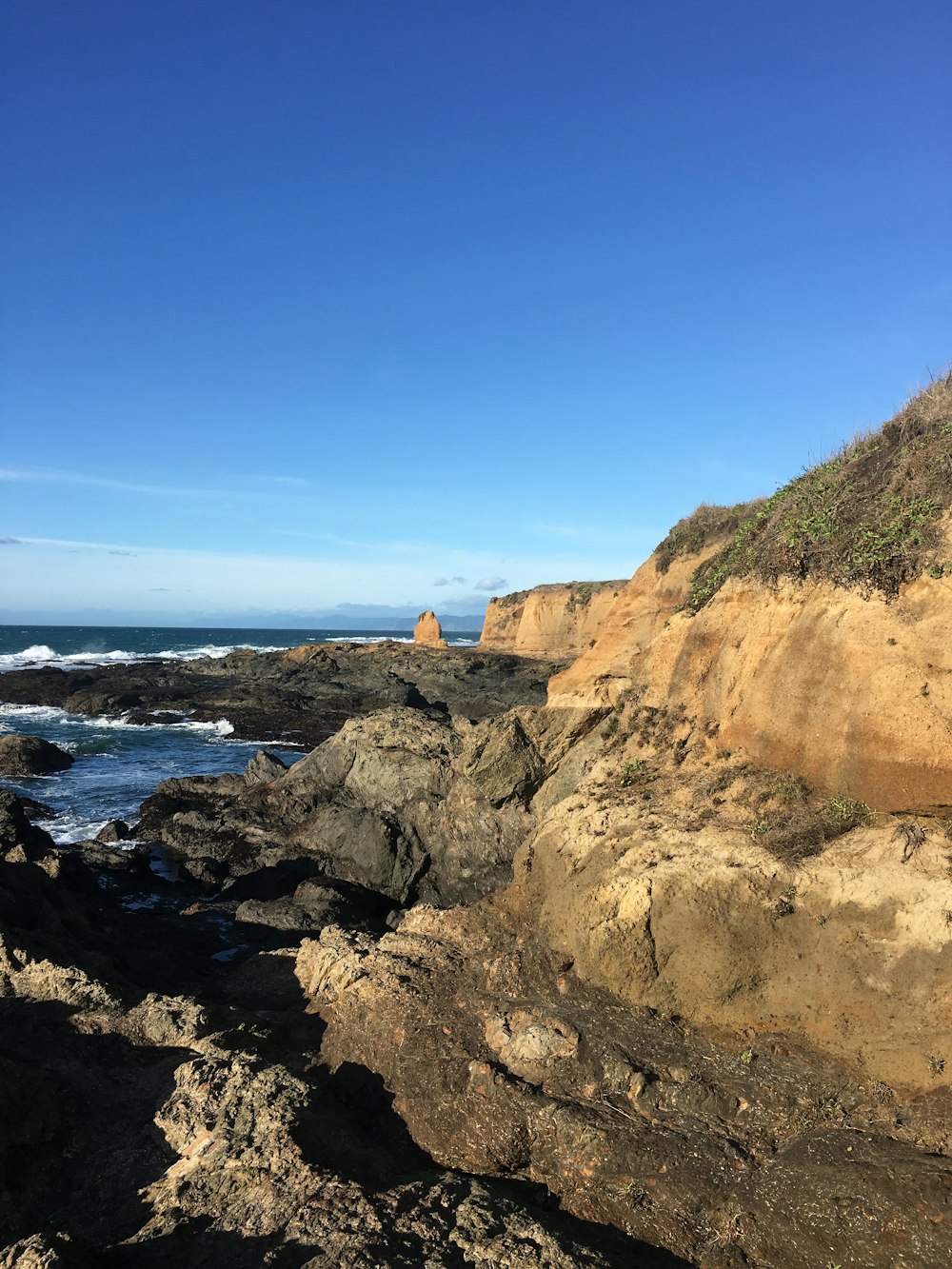 a rocky shore with a body of water