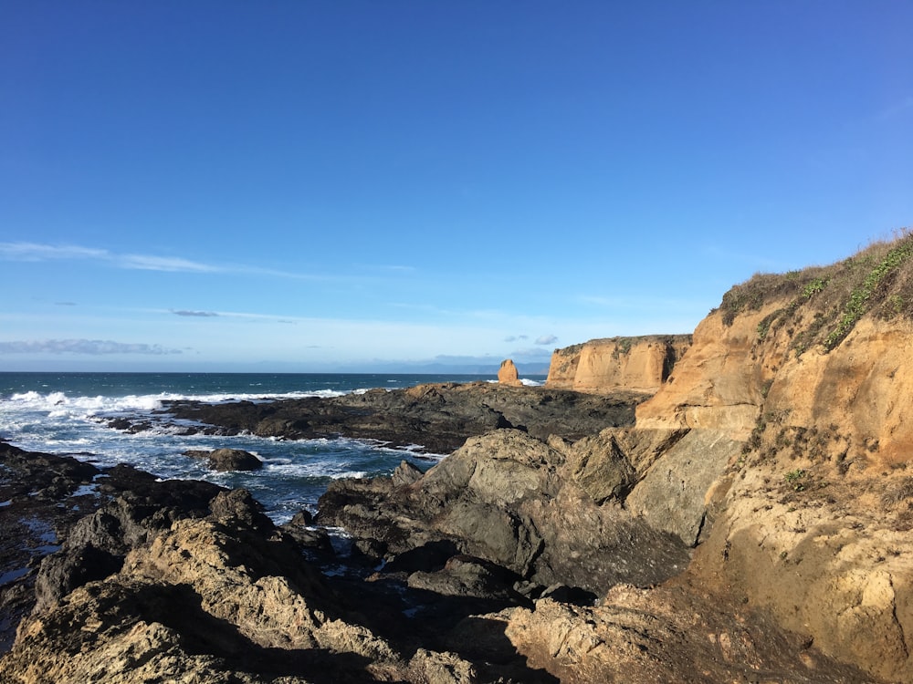 a view of the ocean from a rocky cliff