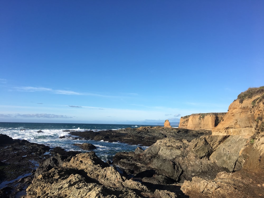 a view of the ocean from a rocky shore