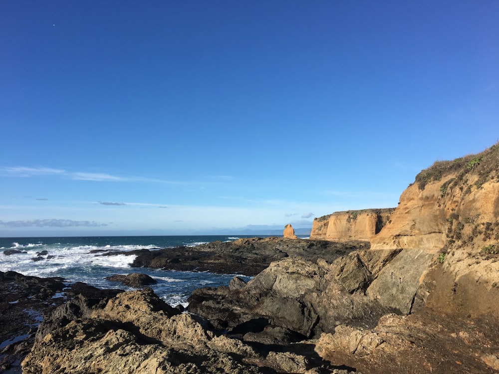 a view of the ocean from a rocky cliff