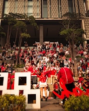 a group of people sitting in front of a building