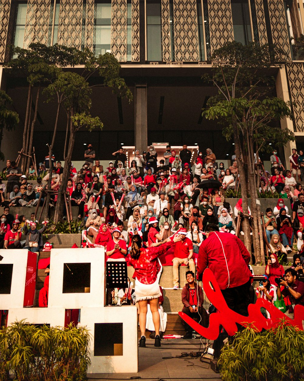 a group of people sitting in front of a building