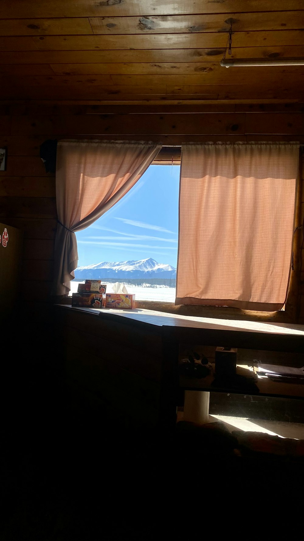 a window with a view of a snowy mountain