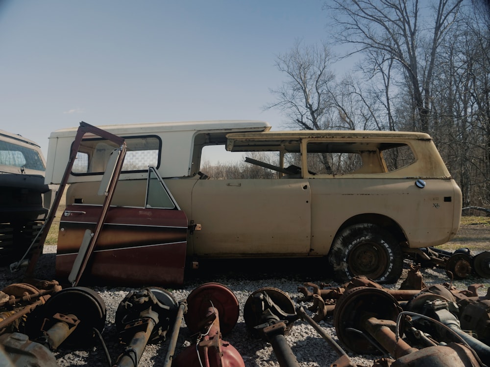 an old van is parked in a junk yard