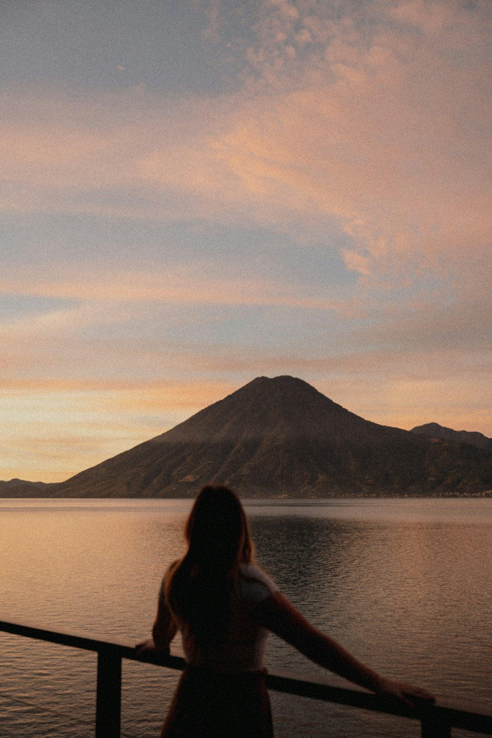 a woman looking out over a body of water