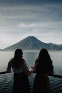 two women looking out over a body of water