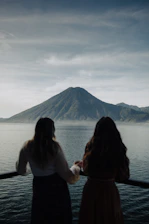 two women looking out over a body of water