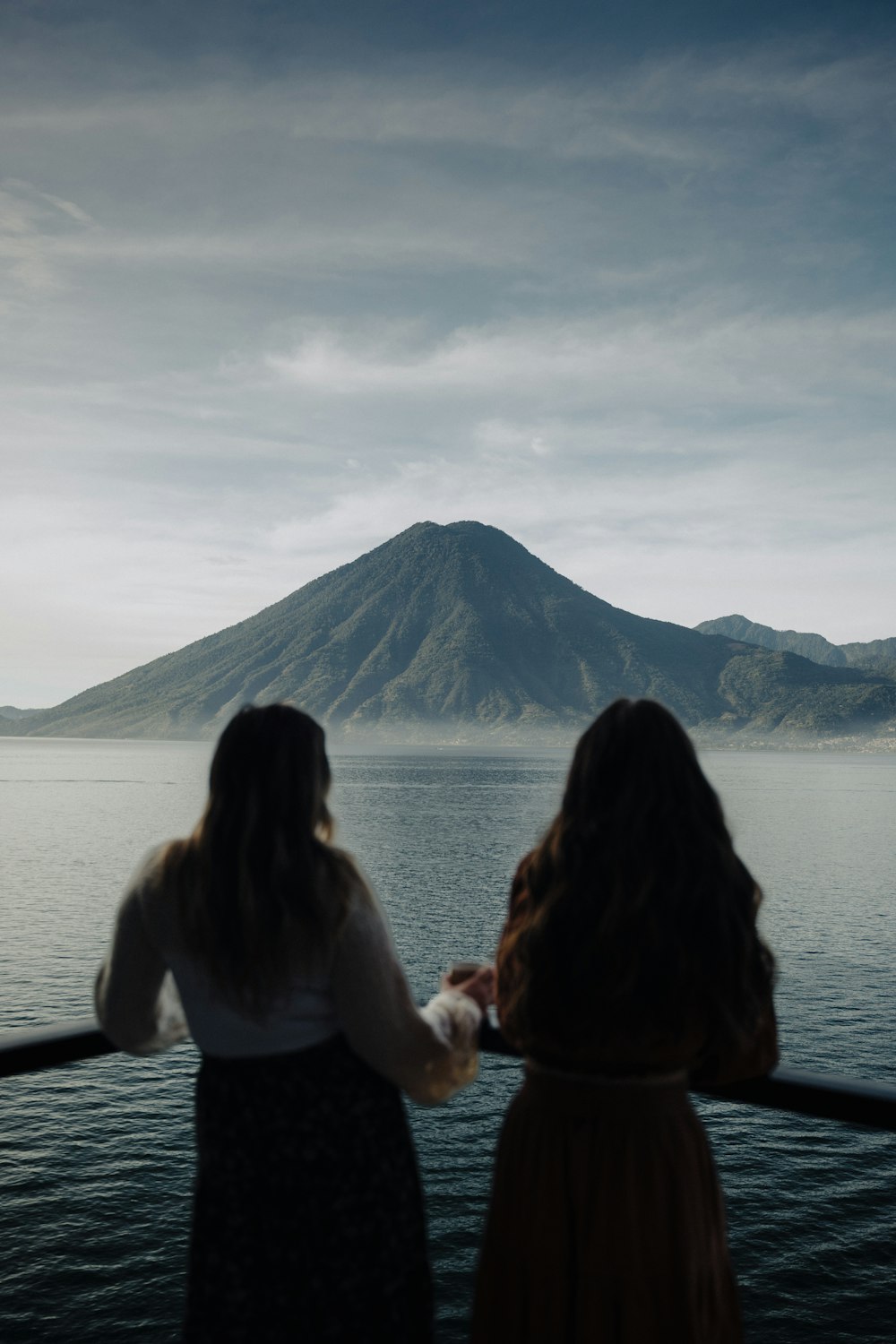 two women looking out over a body of water