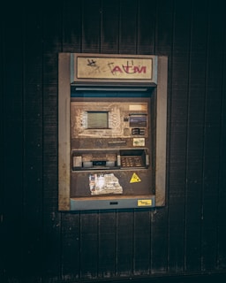an old fashioned pay phone on the side of a building