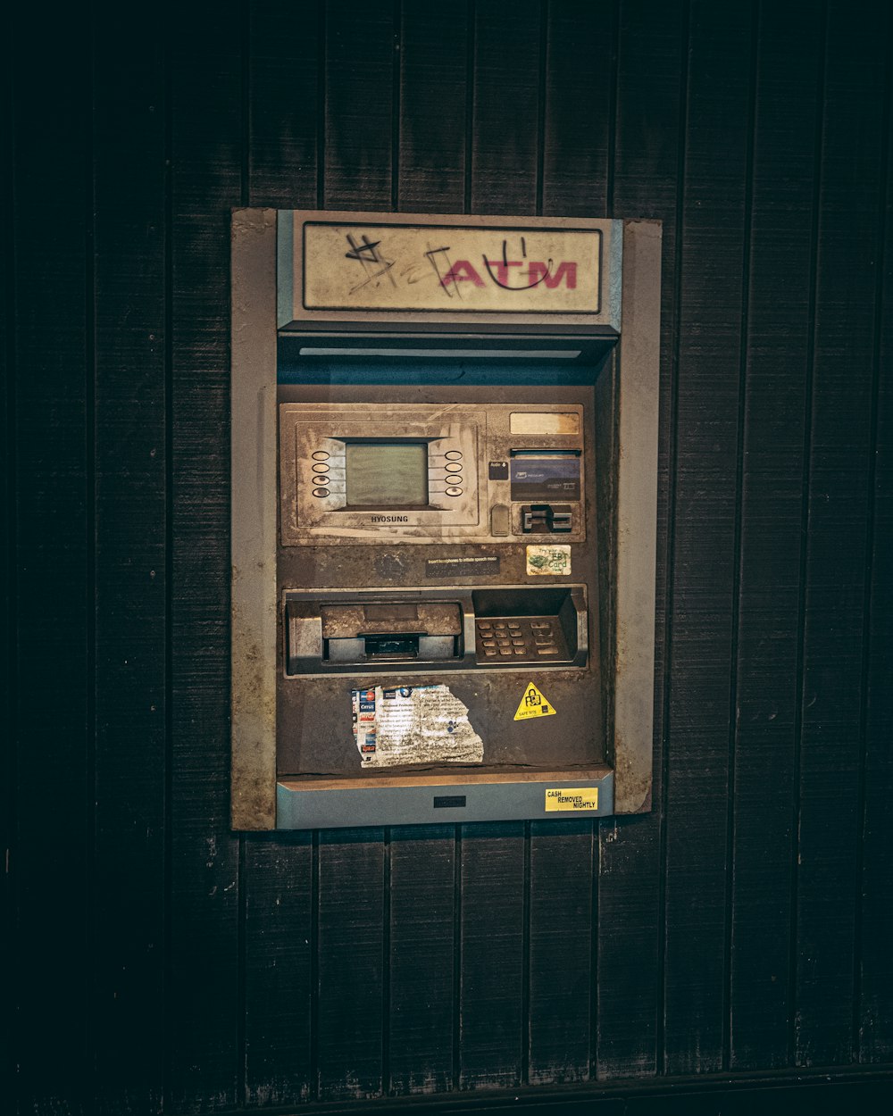 an old fashioned pay phone on the side of a building