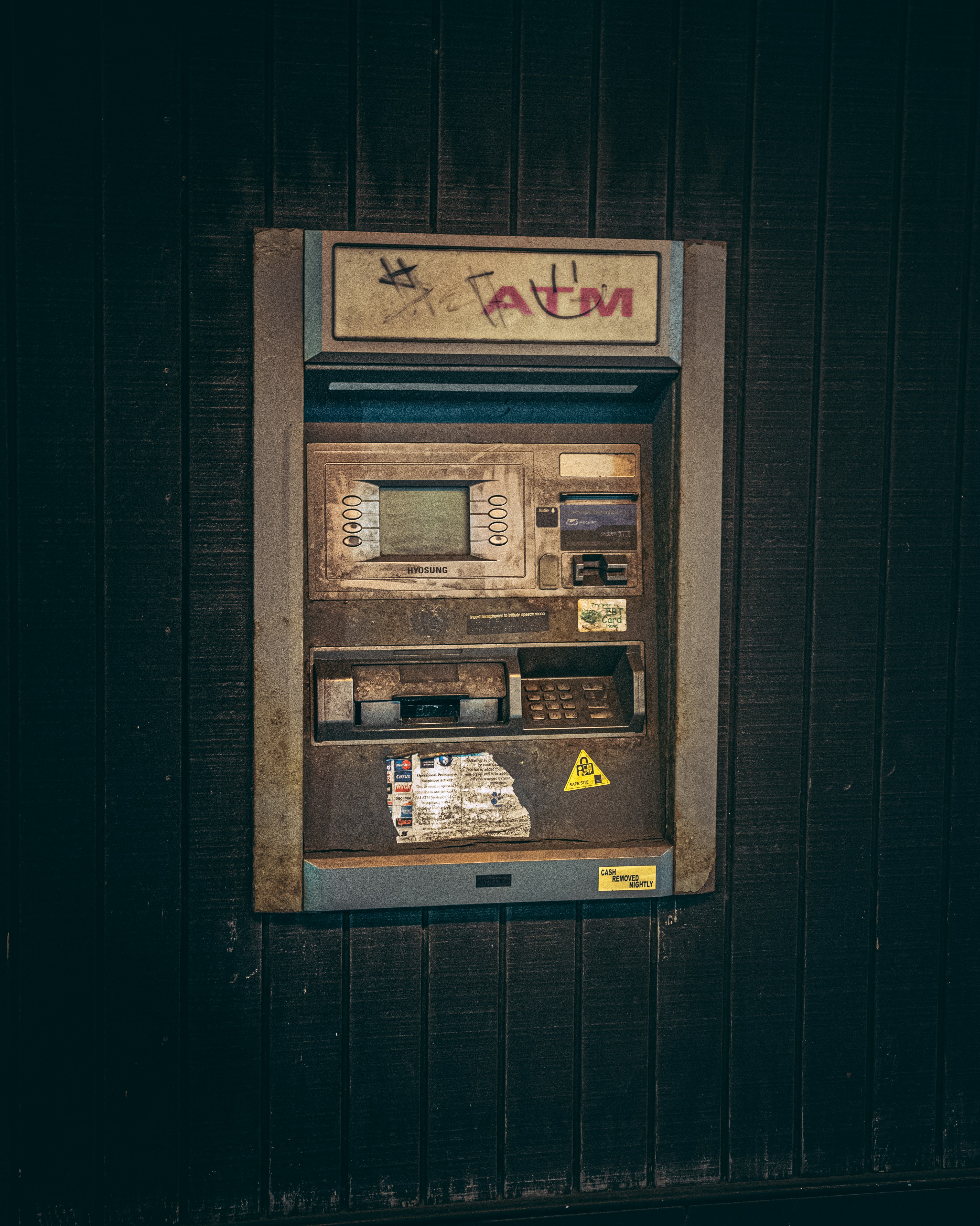 an old fashioned pay phone on the side of a building