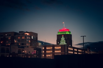 a tall building with a red and green top