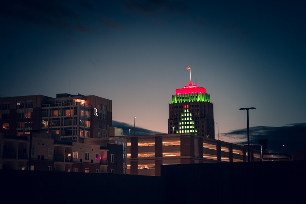 a tall building with a red and green top