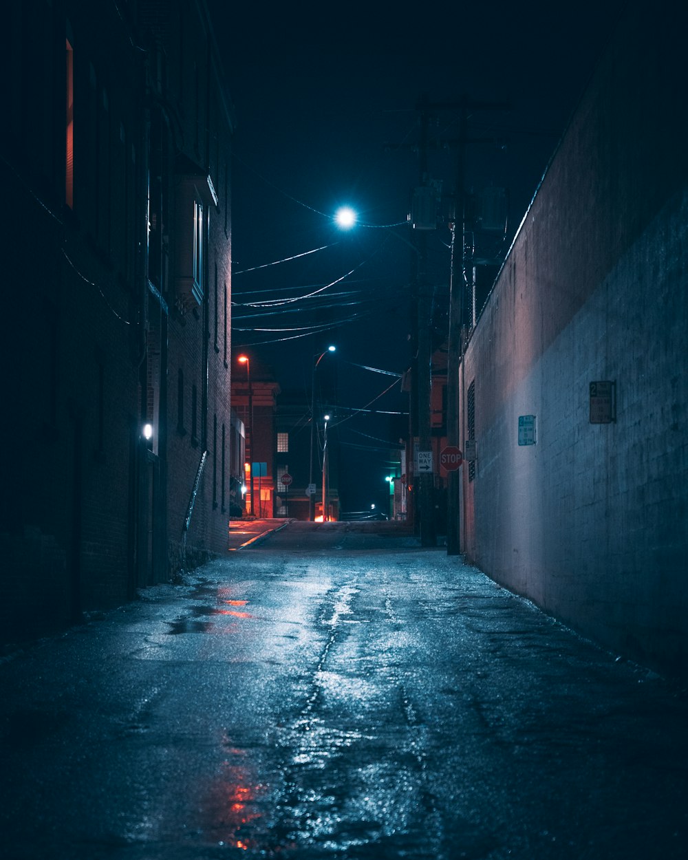 a dark alley at night with a street light