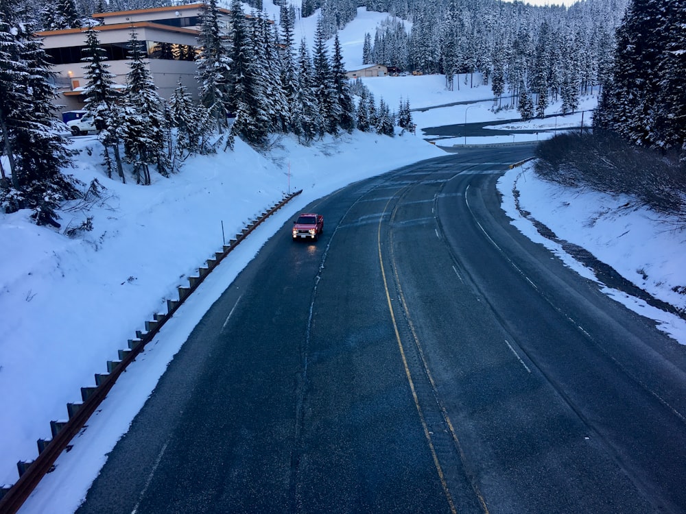 a truck is driving down a snowy road