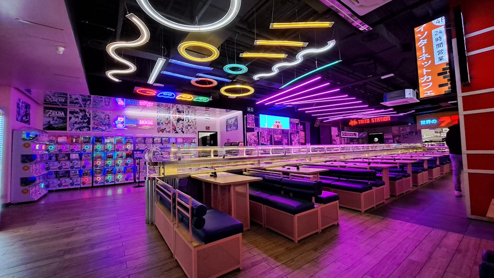 a brightly lit bowling alley with neon lights