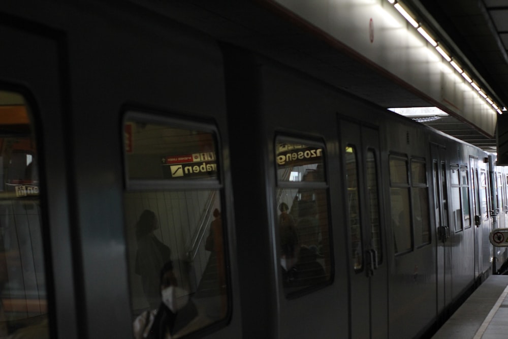 a subway train stopped at a train station