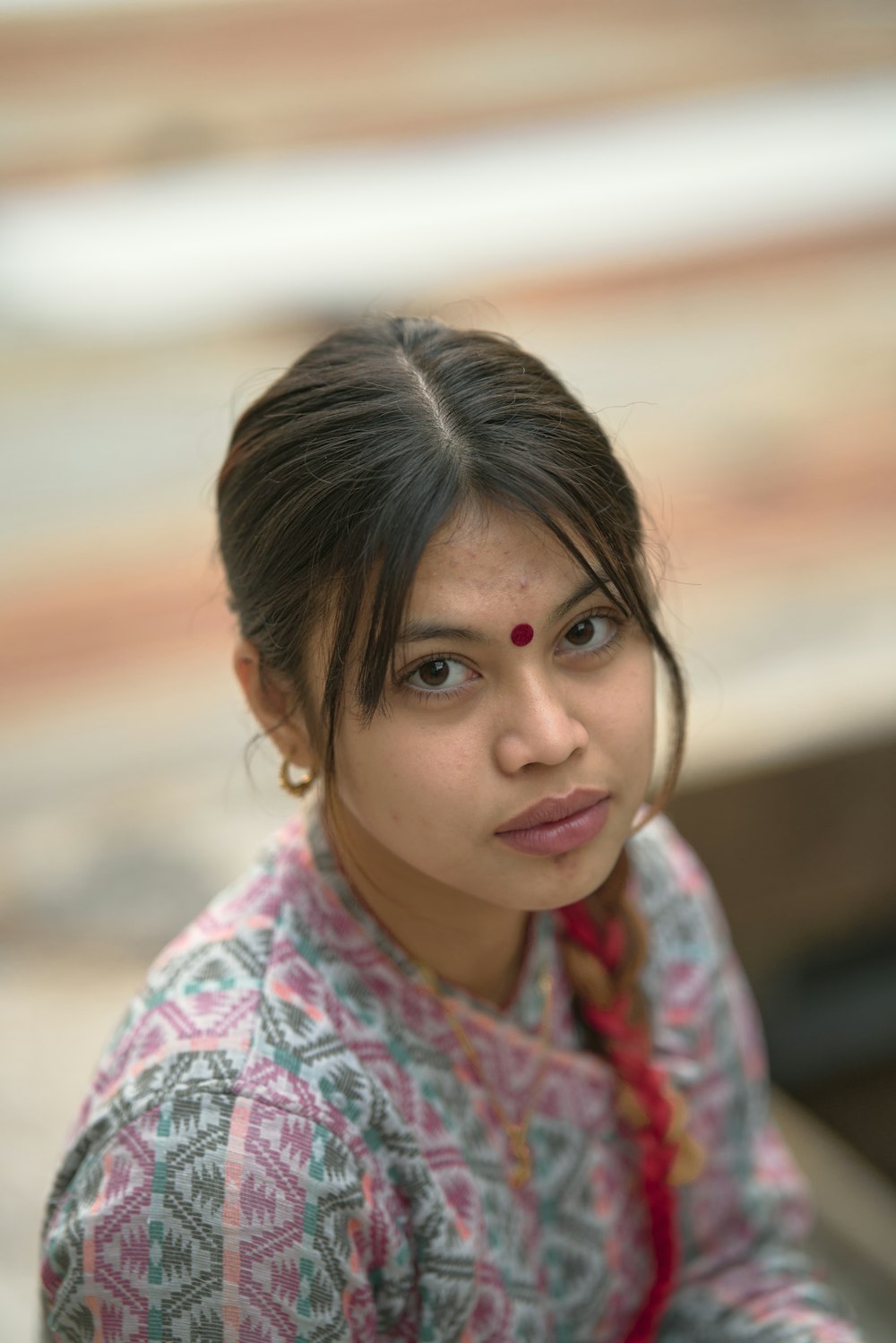 a woman sitting down with a serious look on her face