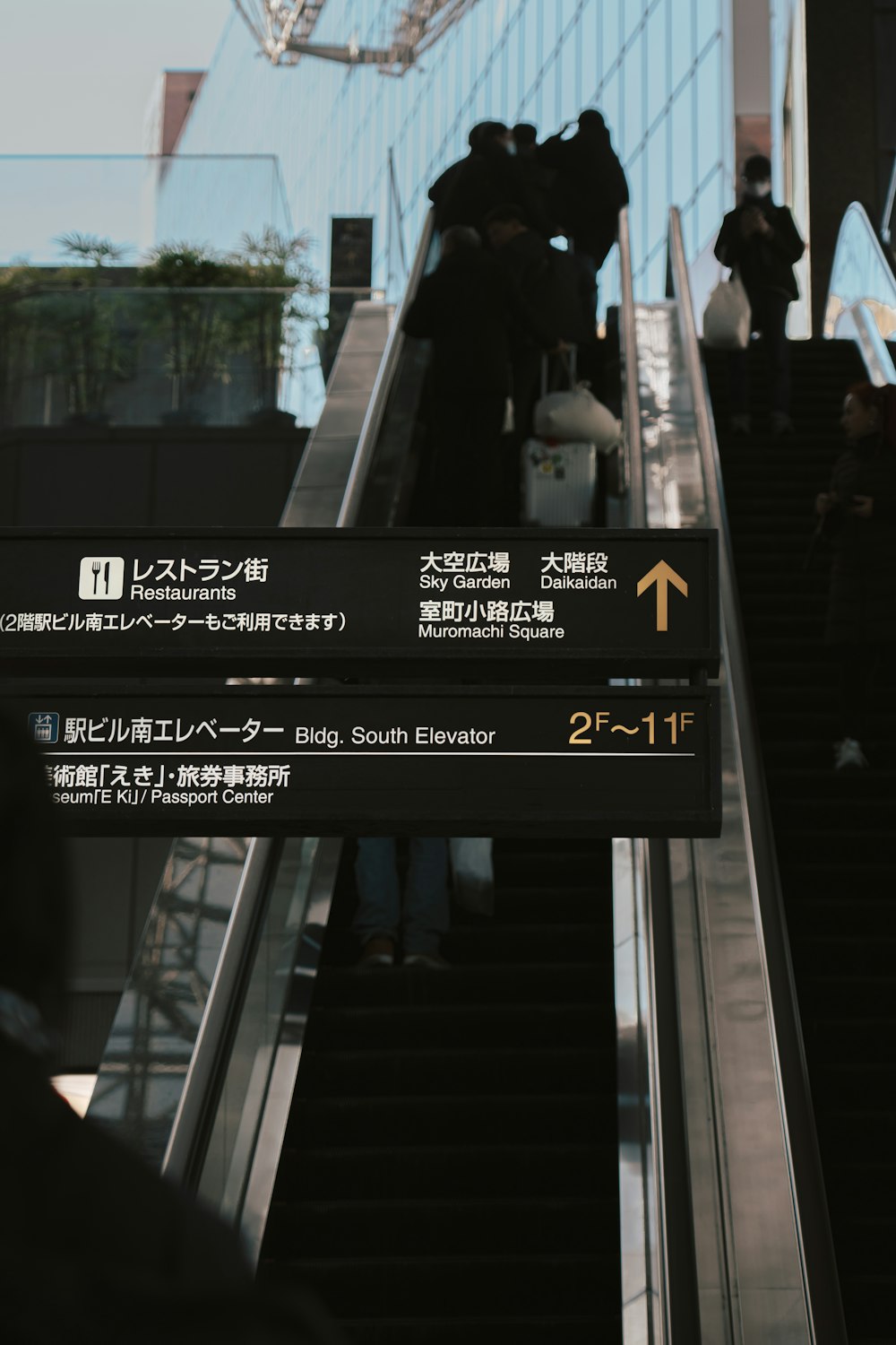 a group of people riding down an escalator