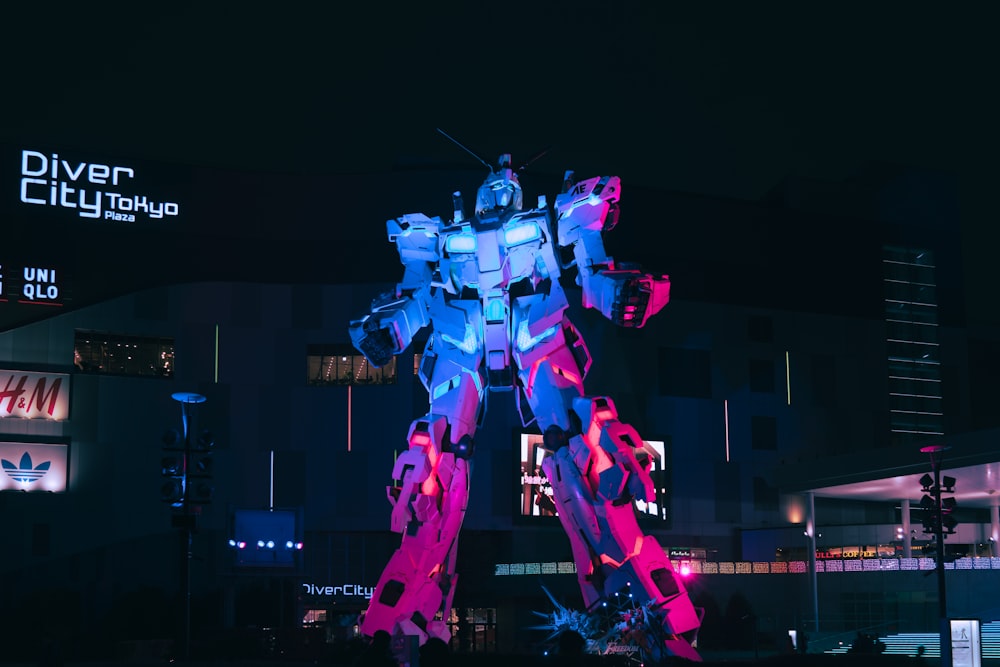 a giant robot statue is lit up at night