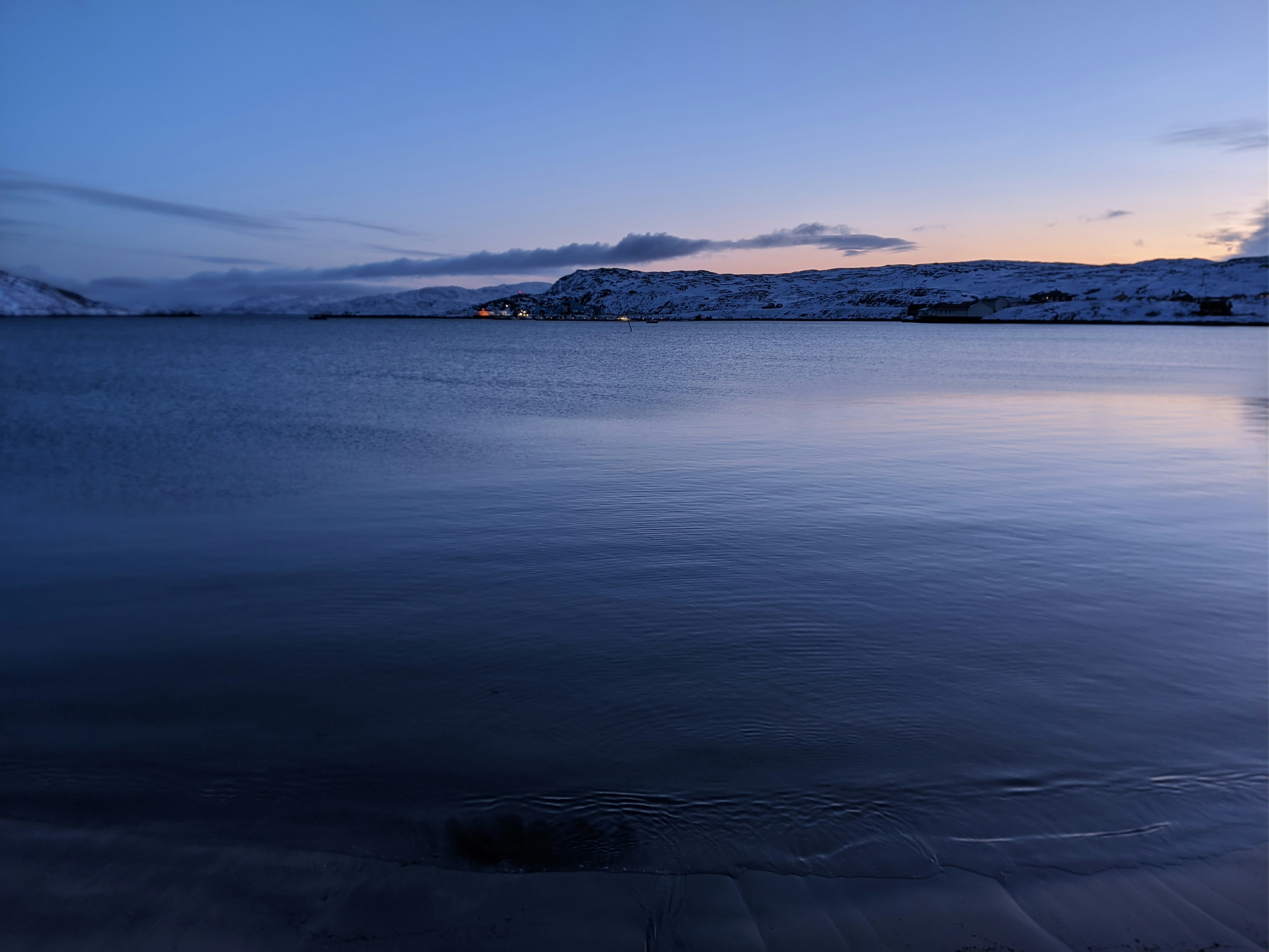 a body of water with a mountain in the background