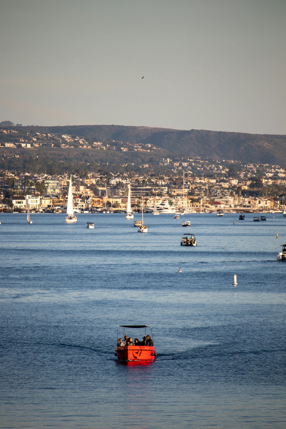 a red boat in the middle of a body of water