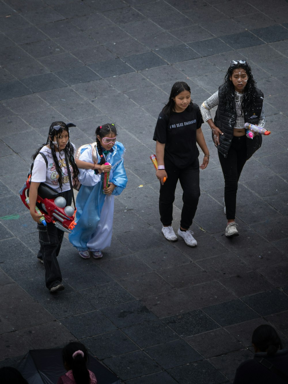 a group of young women walking down a street