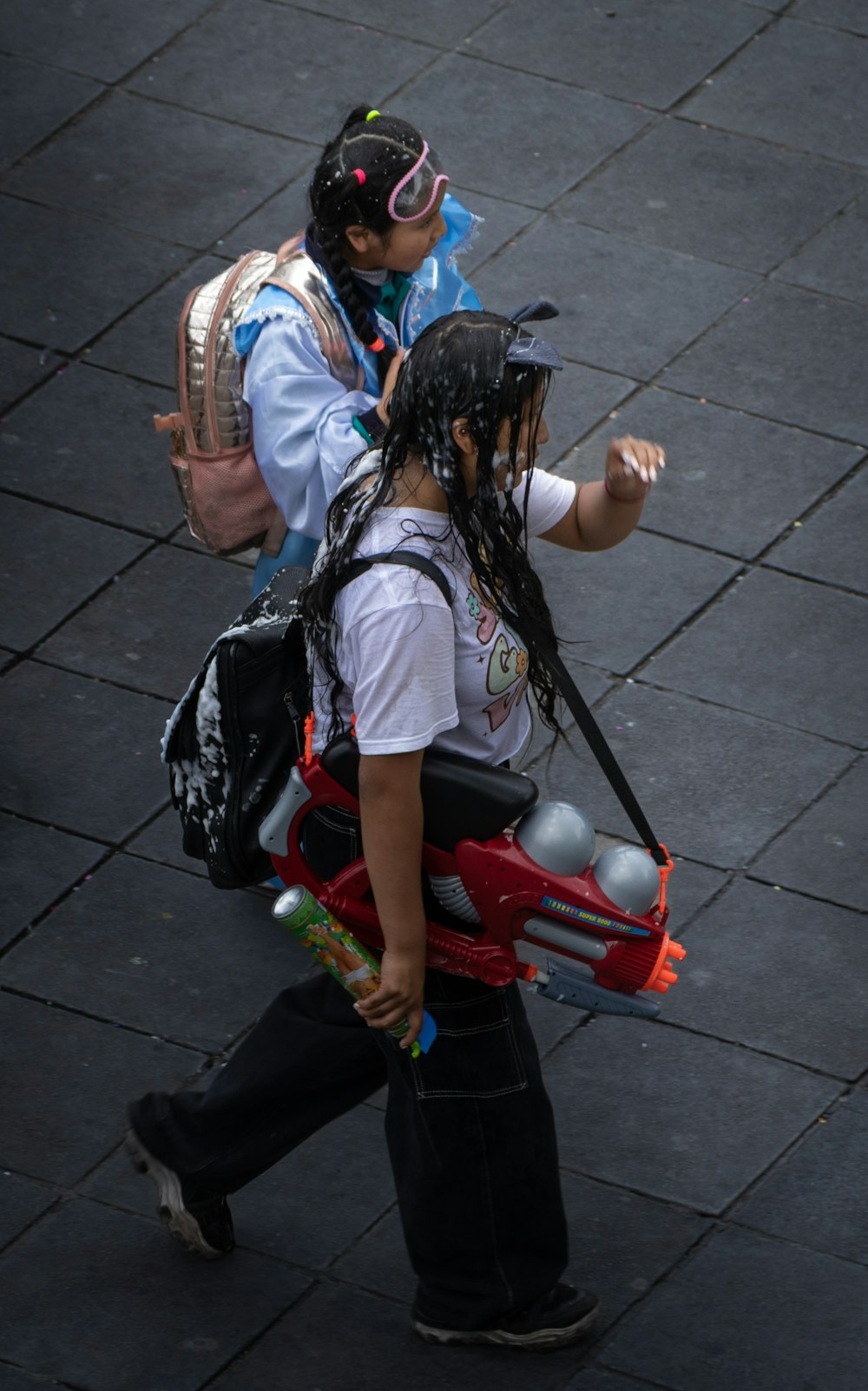 a couple of people walking down a street