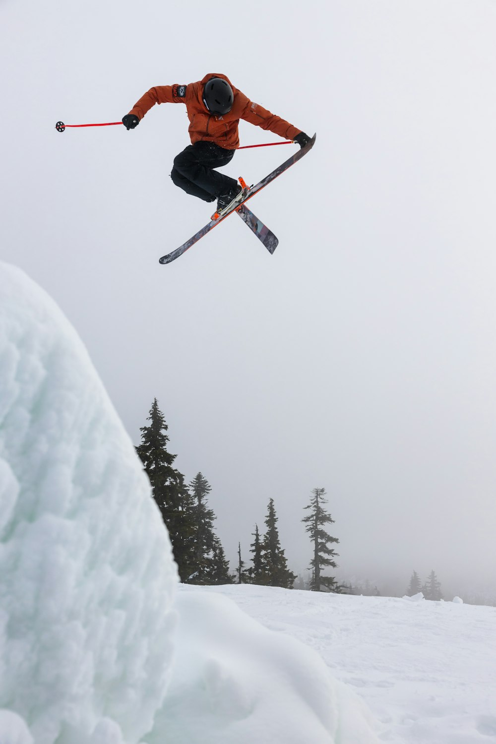 a man flying through the air while riding skis