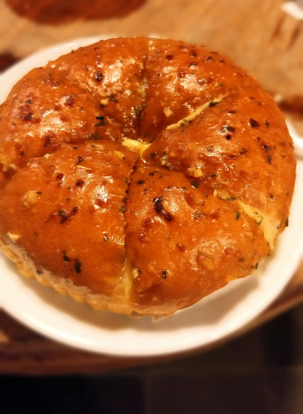 a bun is on a white plate on a table