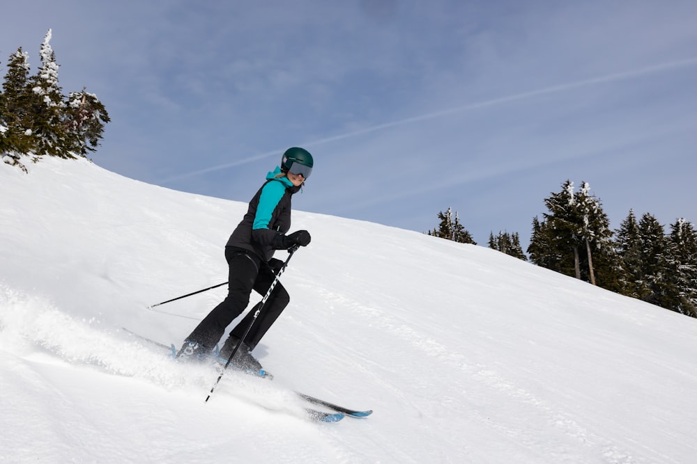 a person riding skis down a snow covered slope