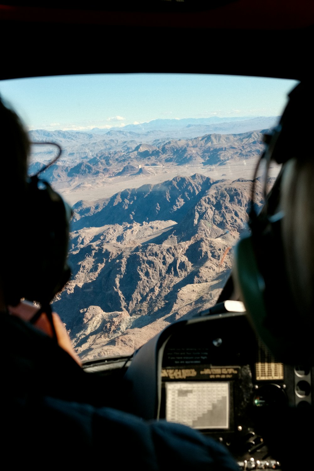 a view of a mountain range from inside a plane