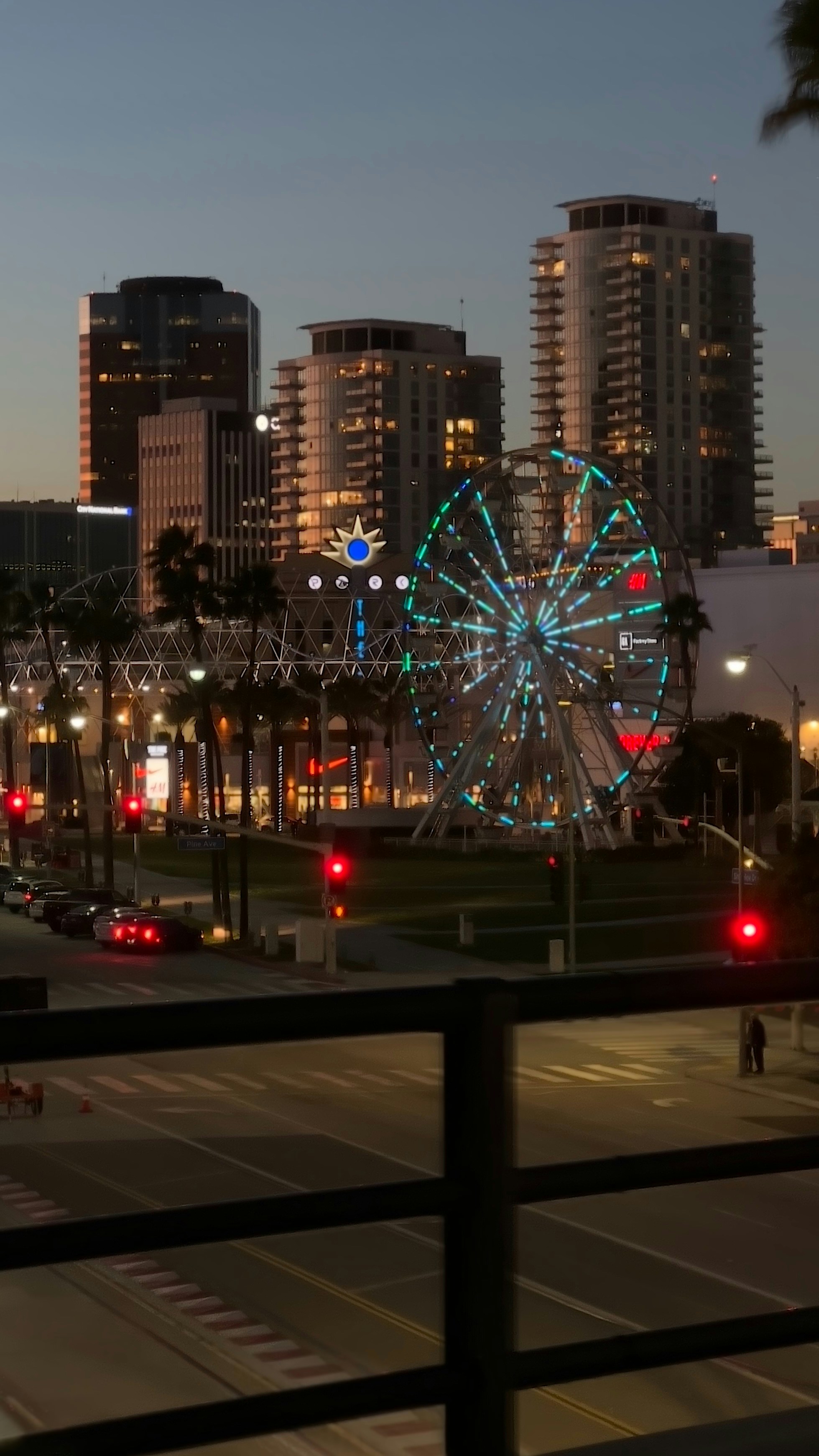 a ferris wheel in the middle of a city at night