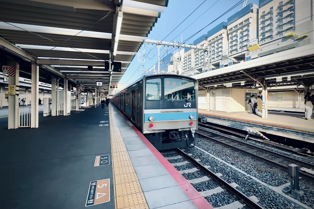 a train pulling into a train station next to a platform