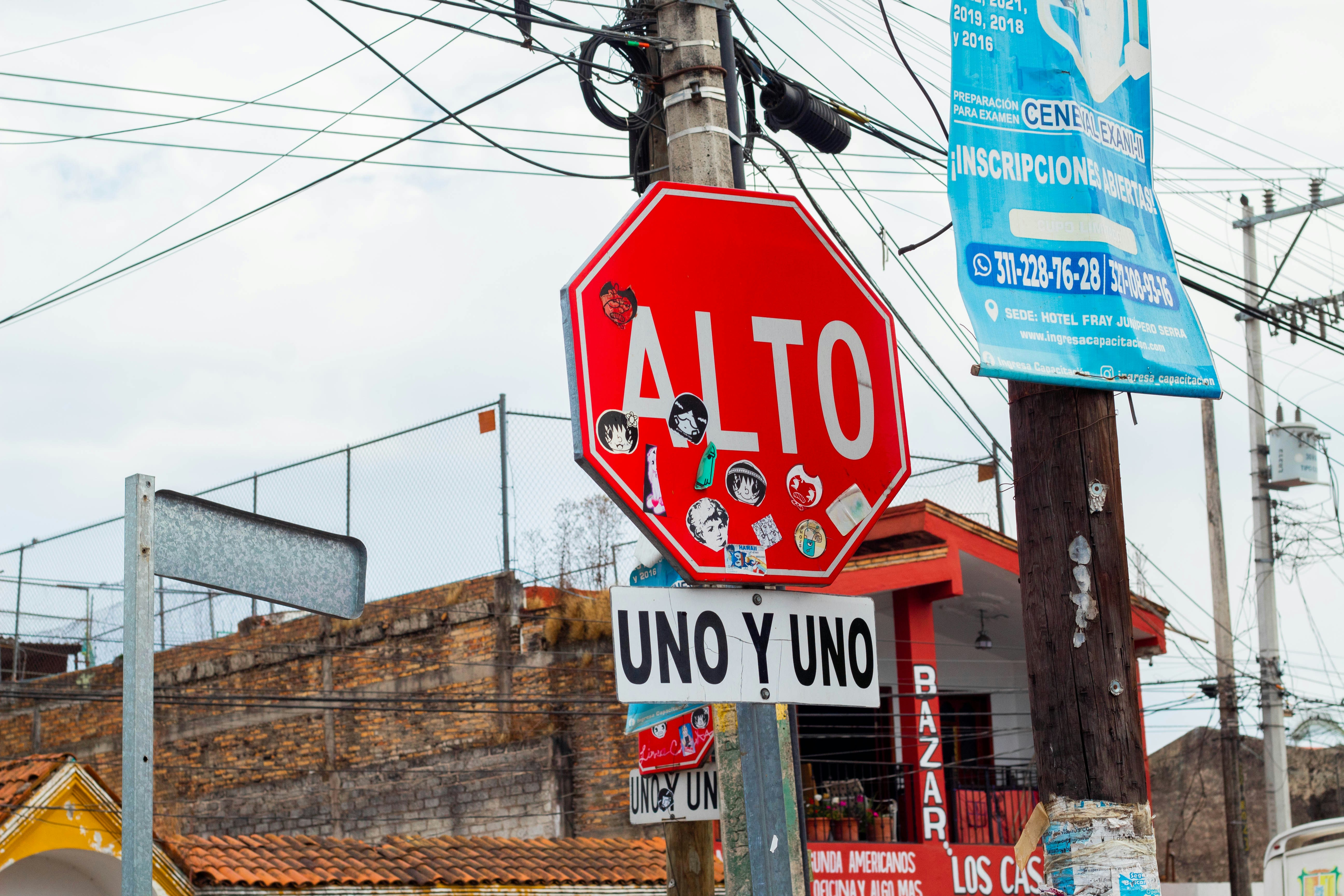 a red stop sign sitting on the side of a road