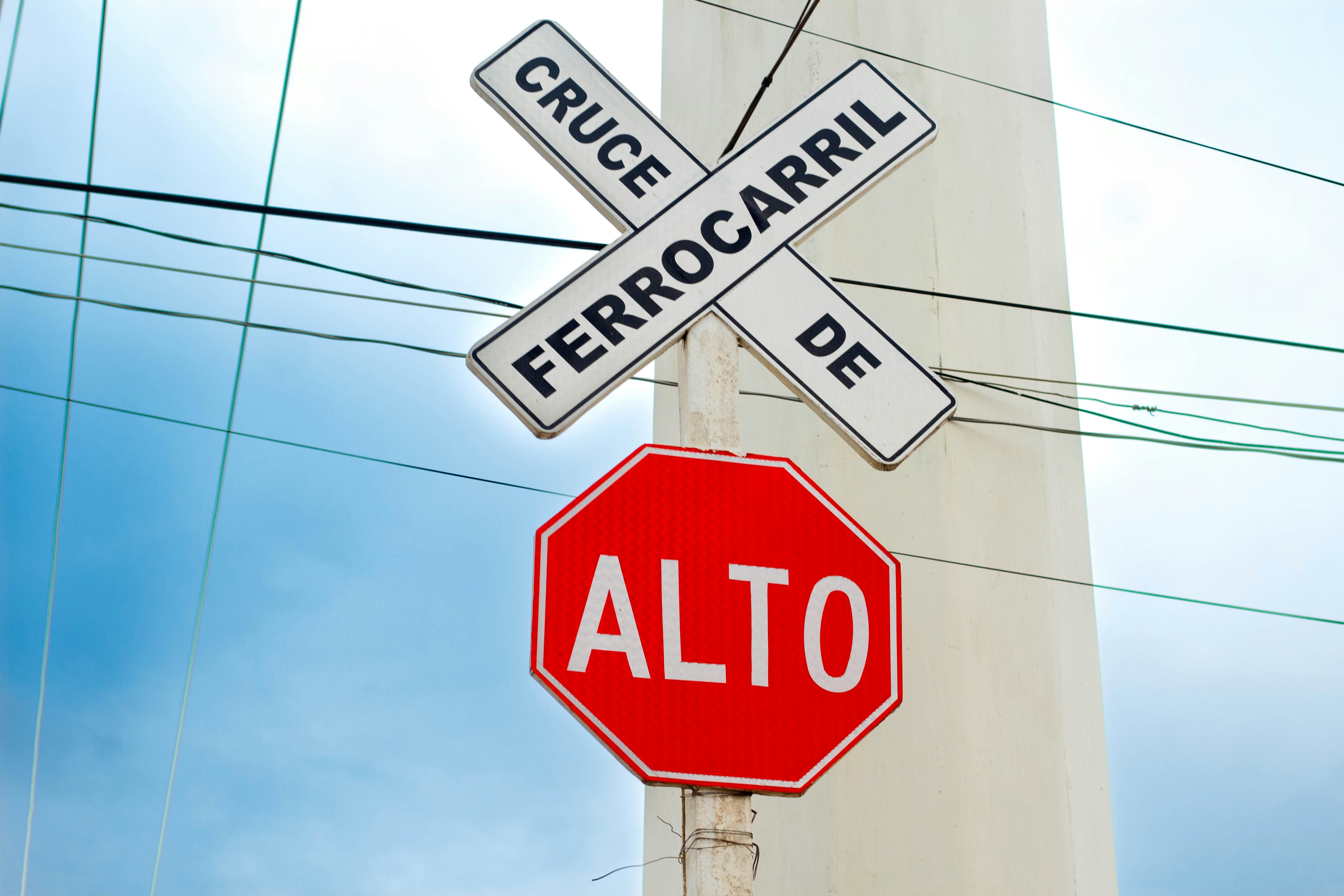 a red stop sign sitting under a street sign