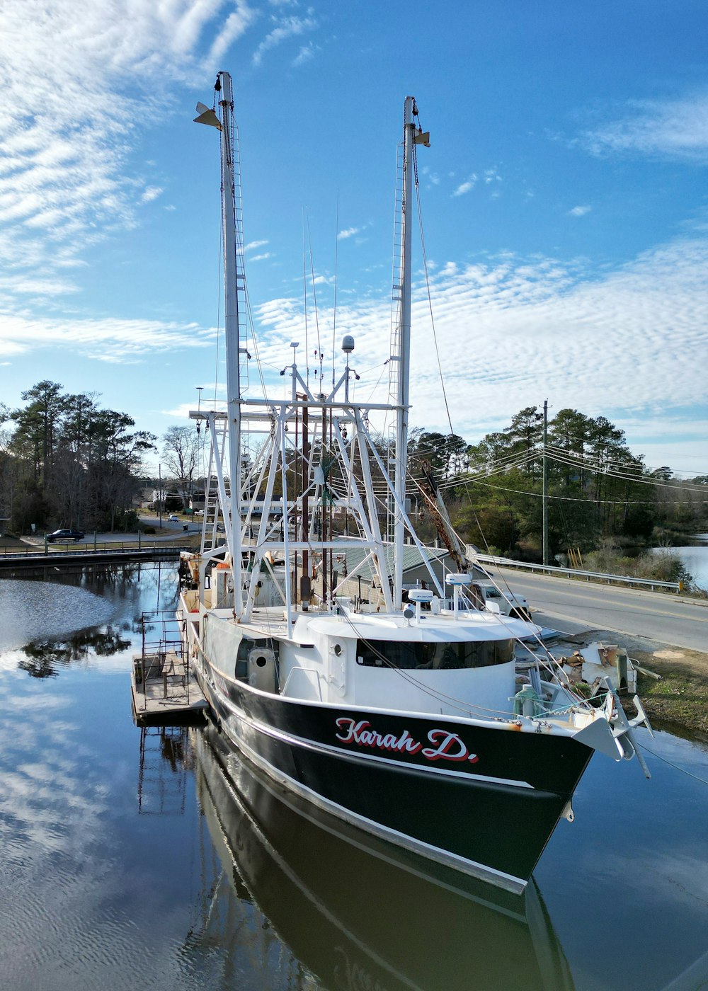 a black and white boat docked at a dock