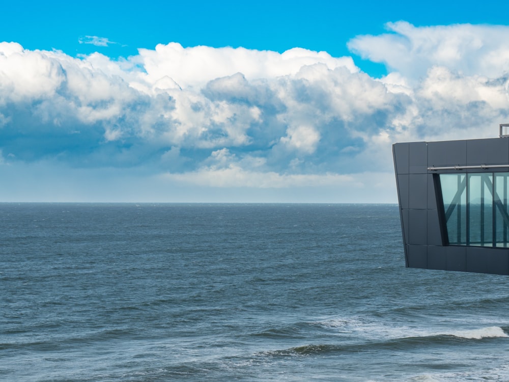 a large body of water sitting under a cloudy blue sky